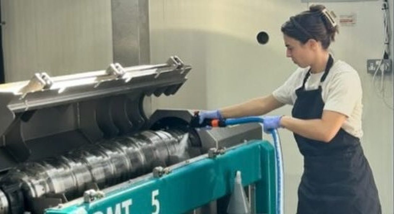 The decanter at the Atsas mill during harvest, a worker at the controls